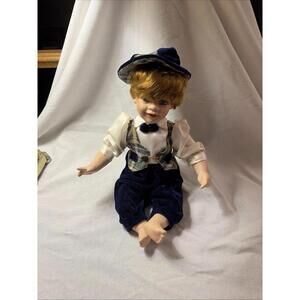 Sitting Porcelain Baby Boy Doll with blue Clothes 10”